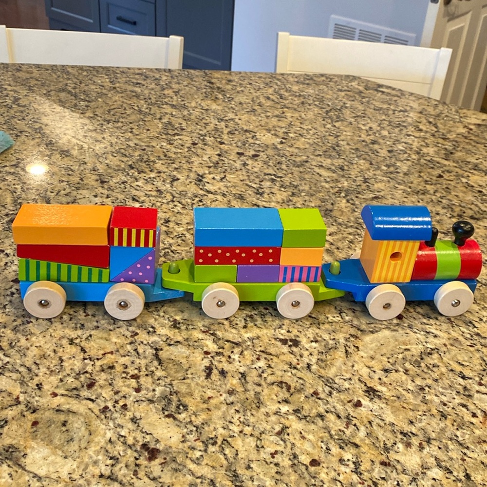 Wooden stacking train. Colorful stacking blocks.